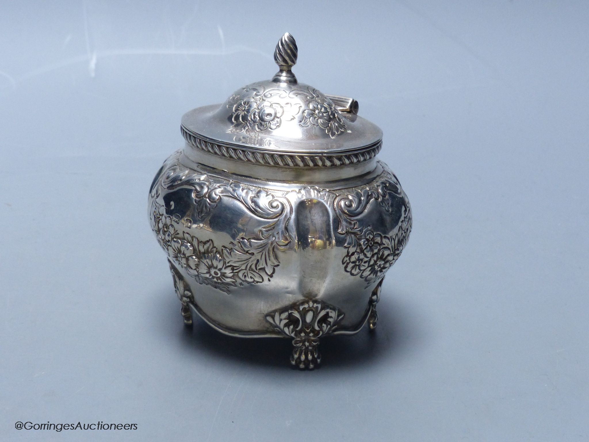 An Edwardian embossed silver bombe shaped tea caddy, Williams (Birmingham) Ltd, Birmingham, 1903, height 11cm, 5.5oz.